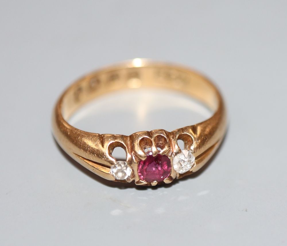 A late Victorian 18ct gold, ruby and diamond three stone ring, size I, gross 3 grams.